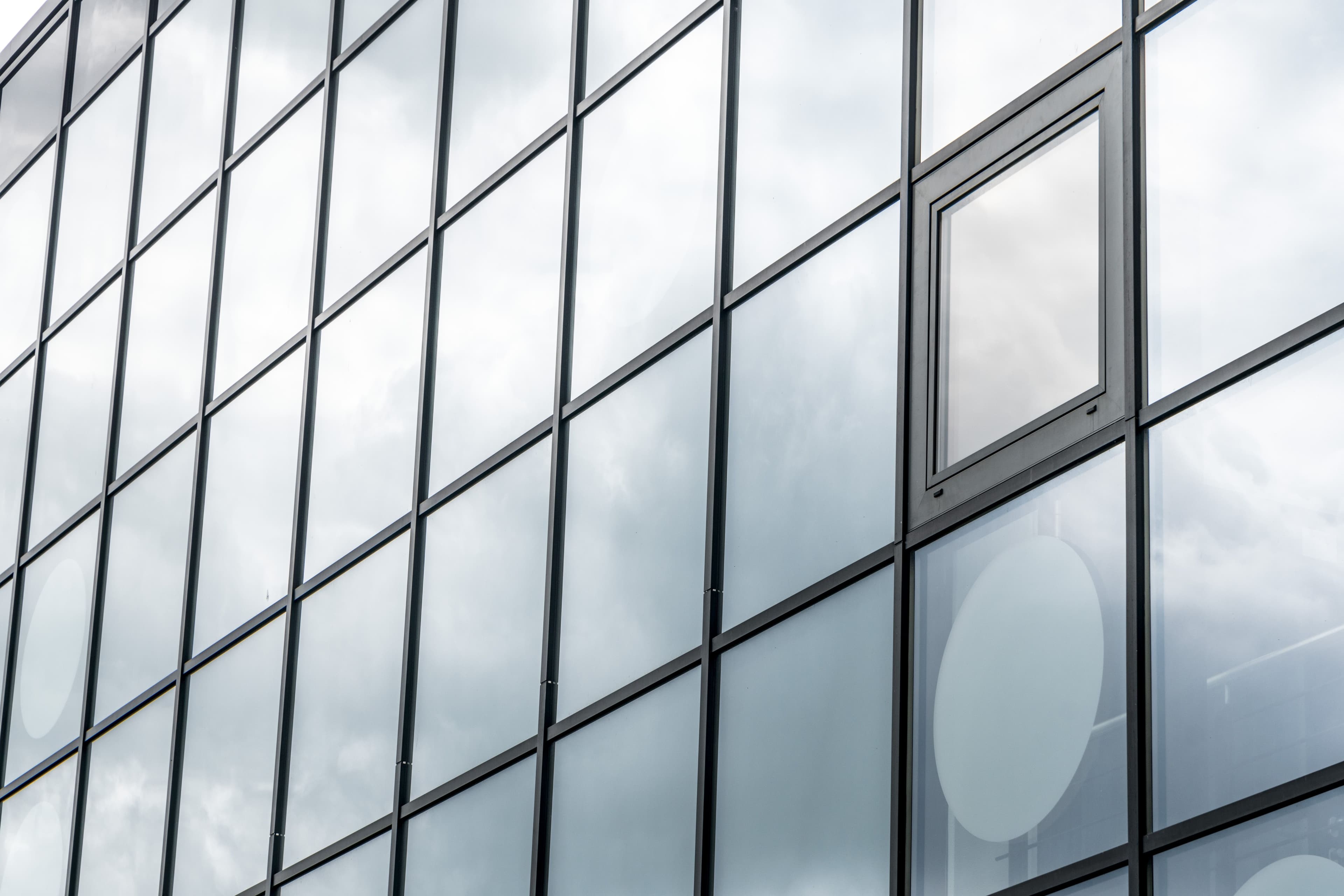Placeholder image of a cleaner washing large commercial windows on an industrial unit
